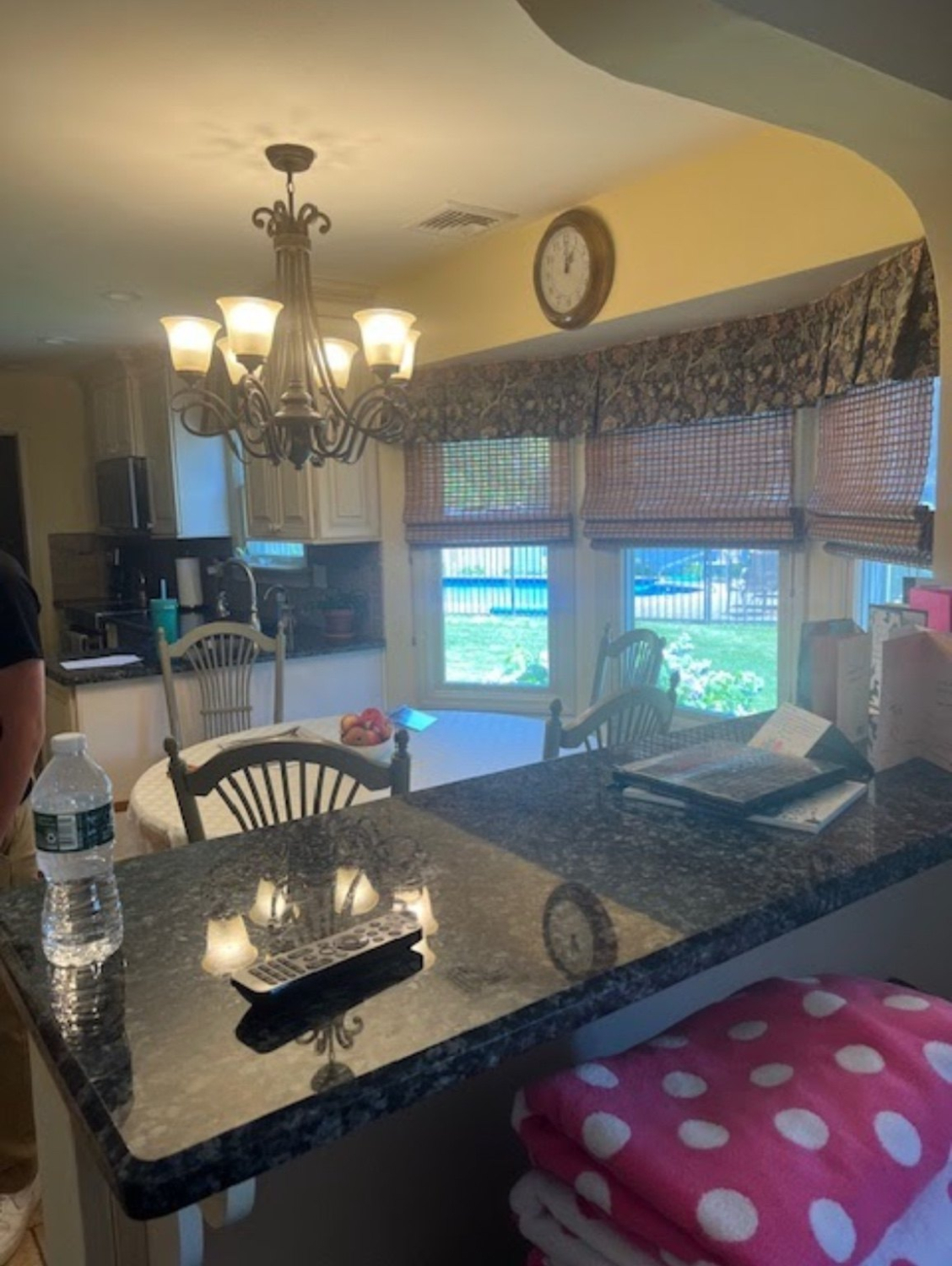 Before: Dix Hills kitchen with dark counters, yellow walls and patterned window treatments